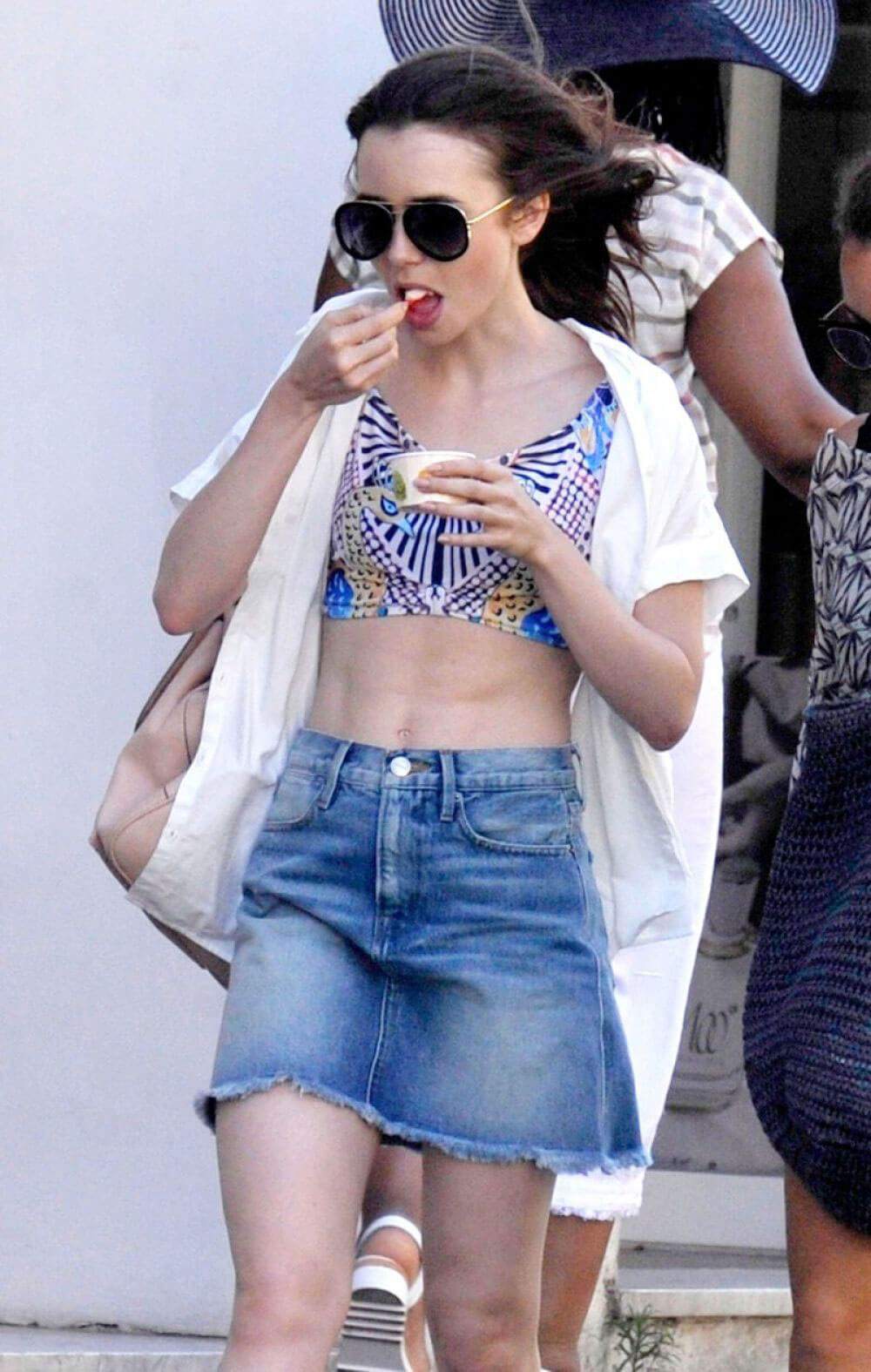 Lily Collins Stills in Denim Skirt Out in Ischia