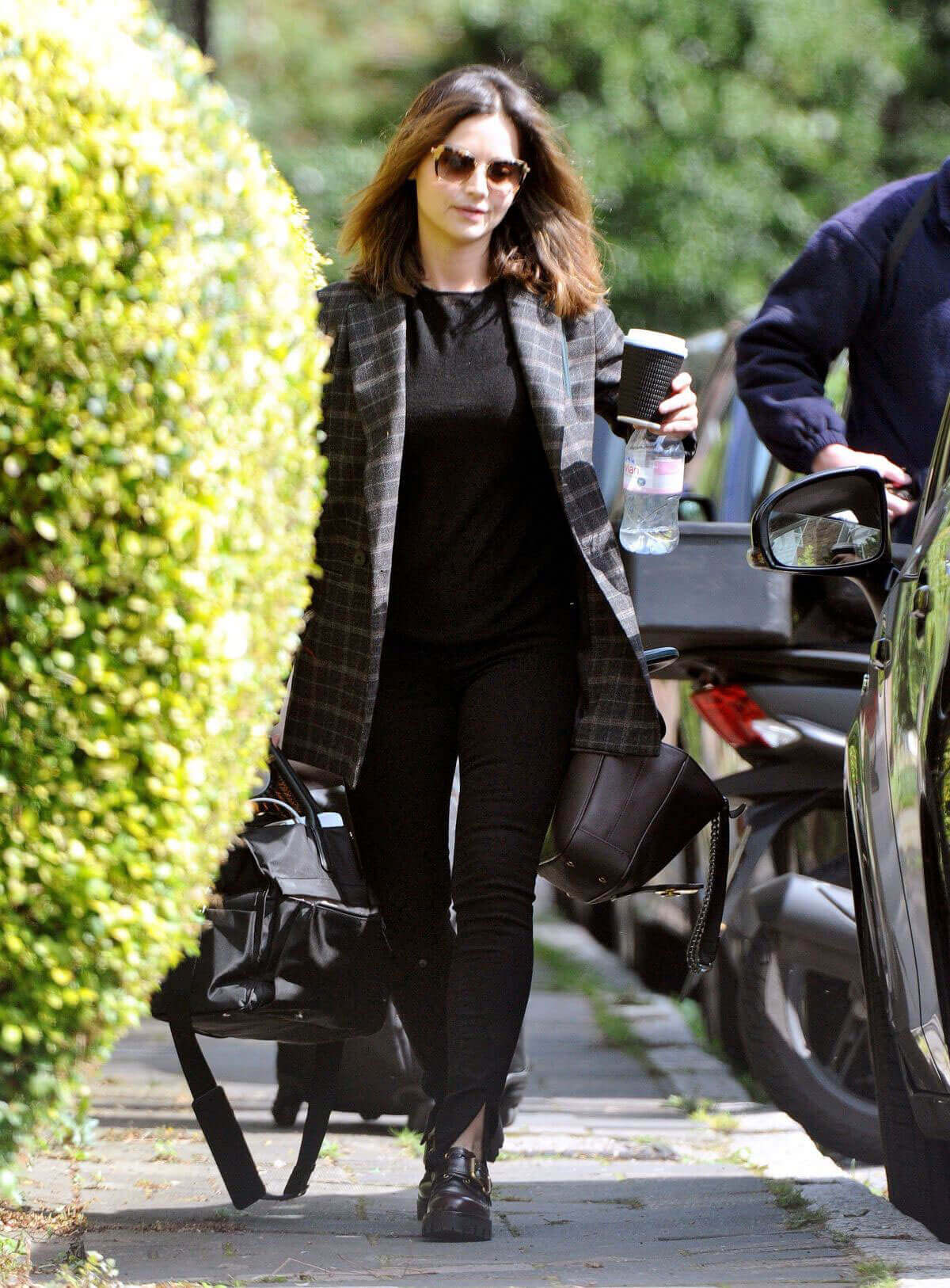 Jenna Coleman wears black top and jeans out and about in London