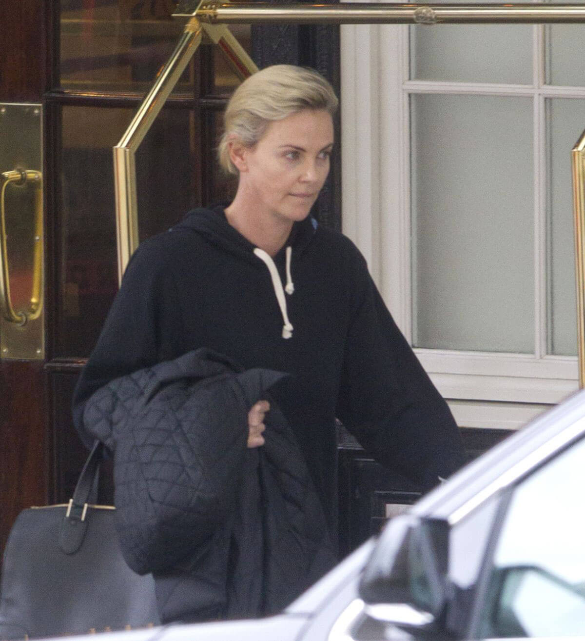 Charlize Theron wears Black Hoodie Stills Leaves Her Hotel in Montreal