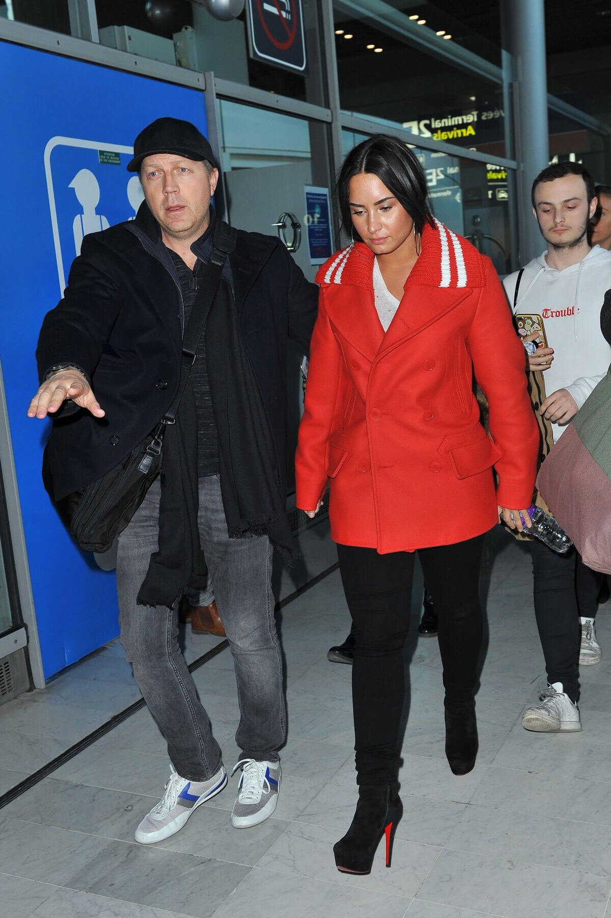 Demi Lovato wears Red Jacket and Black Jeans at Charles De Gaulle Airport in Paris