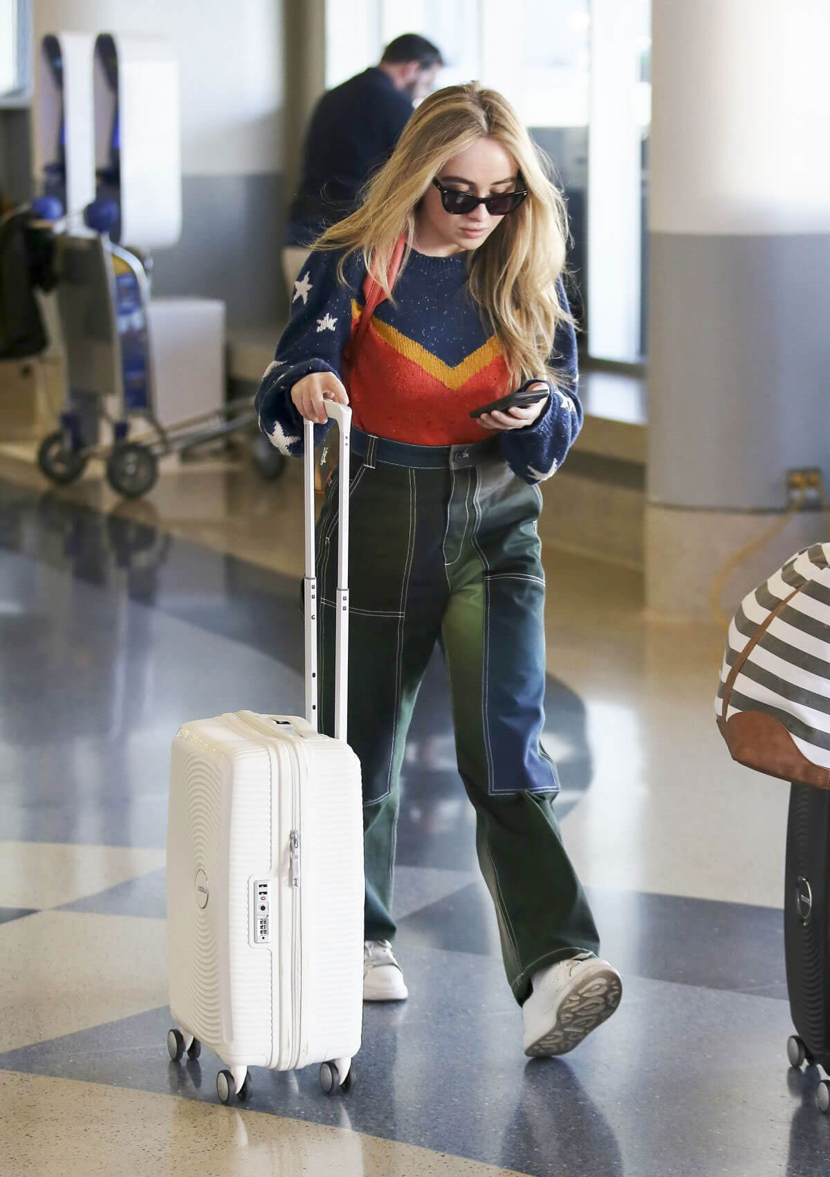 Sabrina Carpenter wears Different Outfits at LAX Airport in Los Angeles