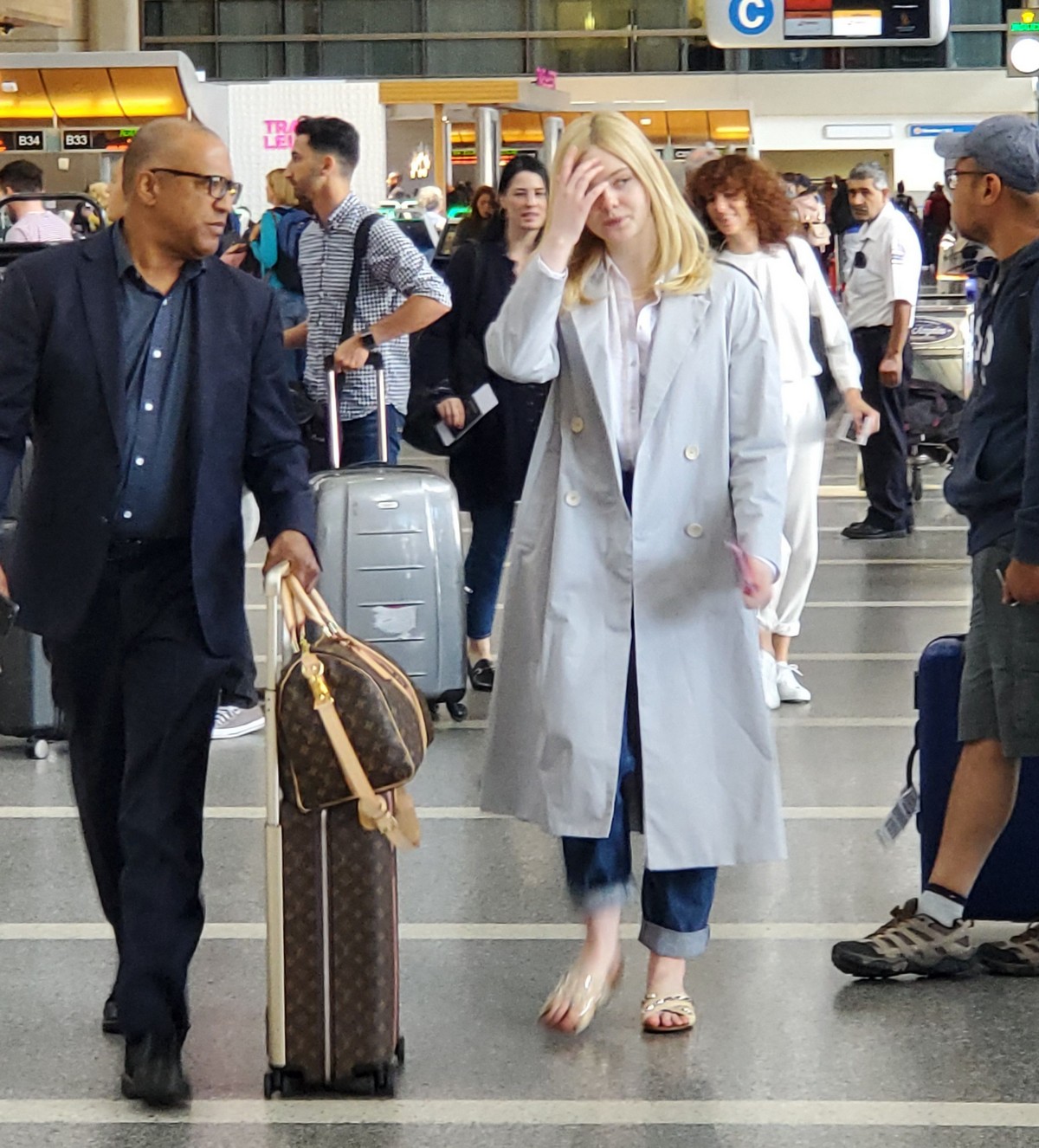 Elle Fanning Visits Boards A Flight at LAX Airport in Los Angeles 2019/05/11