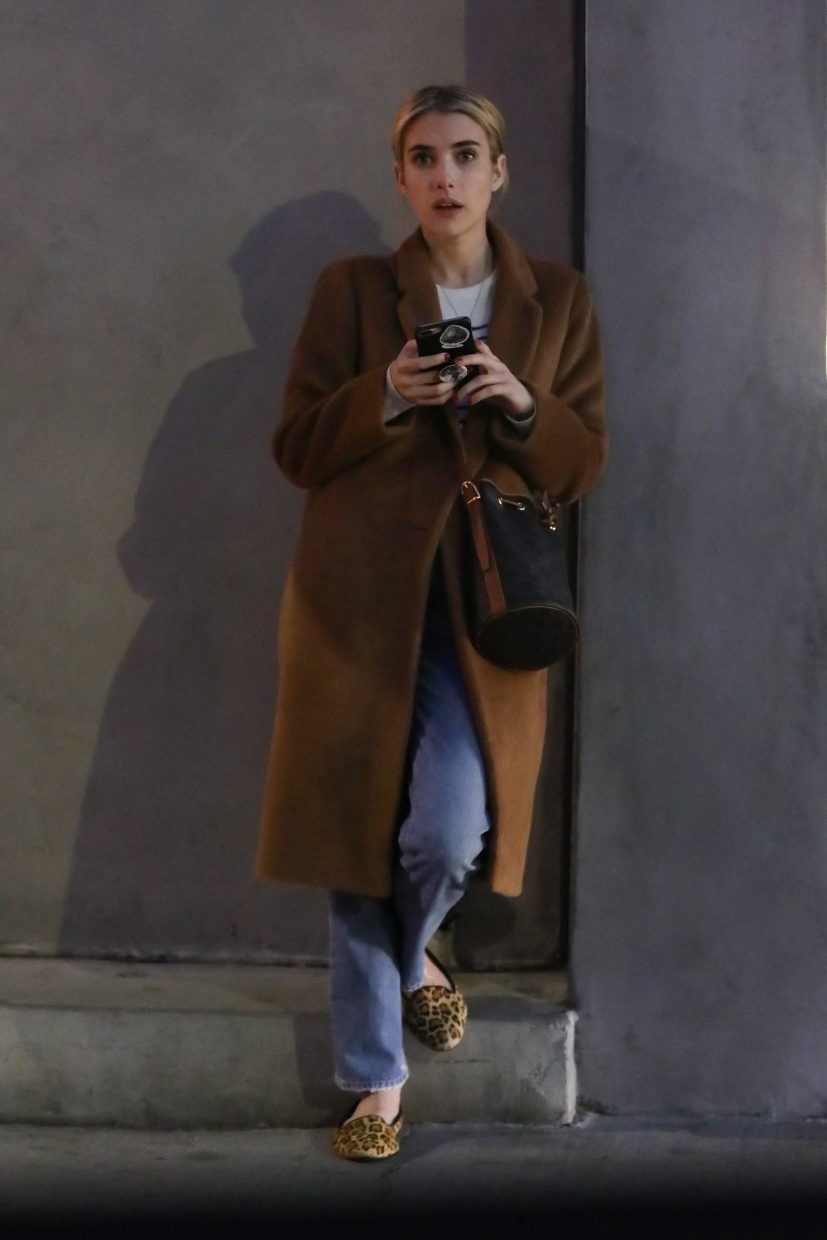 Emma Roberts in long brown coat with blue denim out in Los Angeles, California 2020/03/04