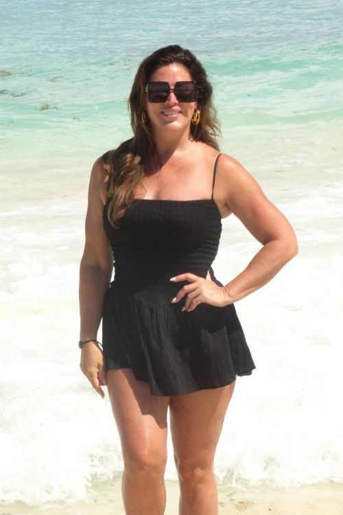 Emily Simpson poses on the beach in Cancun