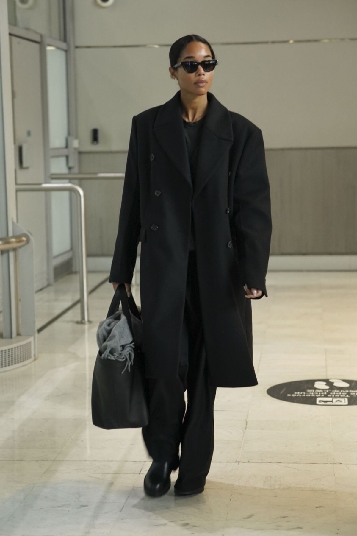 Laura Harrier Wows in Black Ensemble at Paris Airport, January 2025