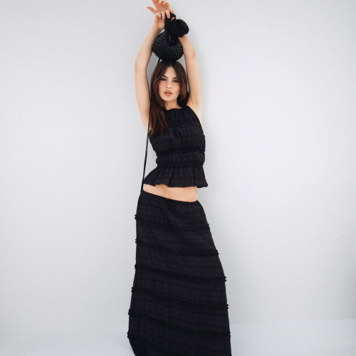 Emily Ratajkowski in black two-piece outfit with textured crop top and maxi skirt for EmRata Collection
