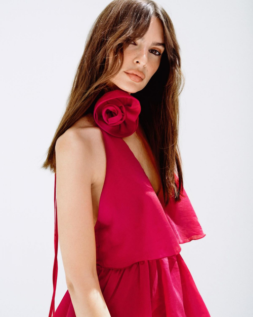 Emily Ratajkowski posing in red halter neck dress with rose detail for NA-KD fashion collaboration