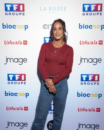 Alice Belaidi wearing a fitted burgundy long-sleeved top