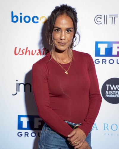 Alice Belaidi wearing a burgundy top and high-waisted jeans