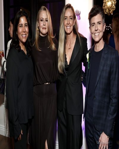 Alicia Silverstone wearing a contemporary black dress with flattering shape