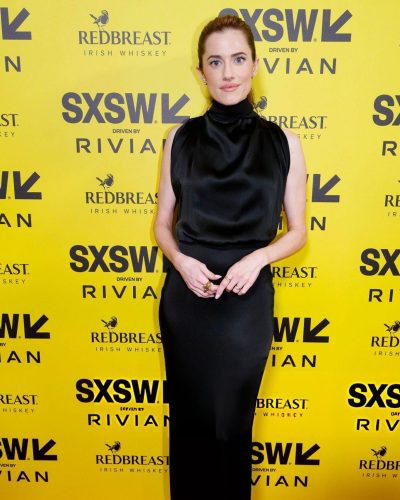 Allison Williams in classic black gown paired with statement rings.