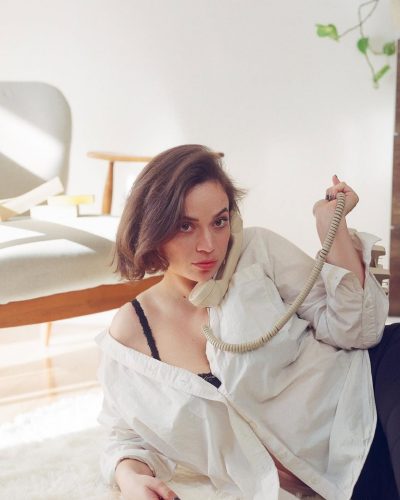 Angela Giarratana black skirt alongside relaxed white shirt