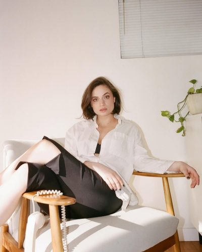 Angela Giarratana black skirt and loose white shirt ensemble