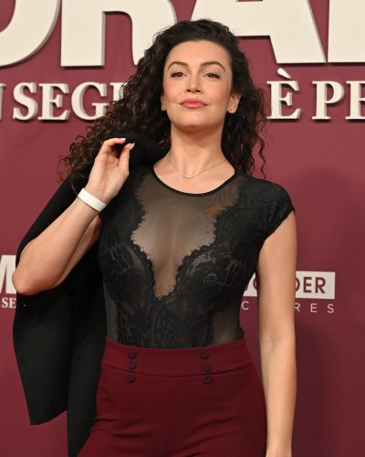 Angelica Baraldi in sleek burgundy pants with button detail