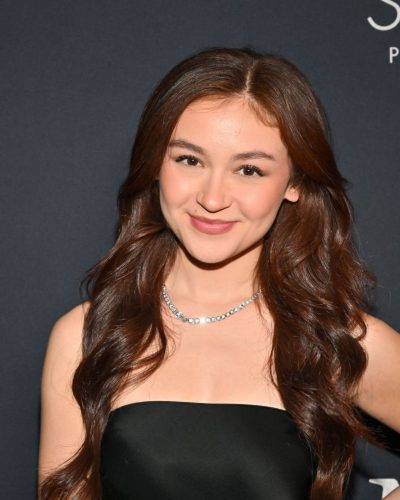 Anna Cathcart in a minimalist black gown with statement necklace.