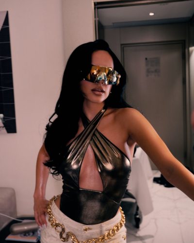 Becky G shimmering metallic top reflecting light beautifully