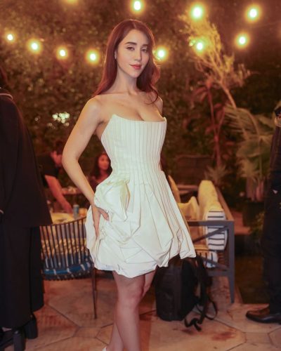 Caylee Cowan wearing stylish white heels with ankle straps.