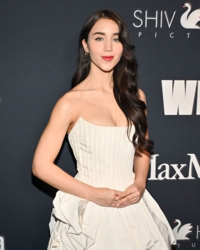 Caylee Cowan in a flowing white gown with soft draping.