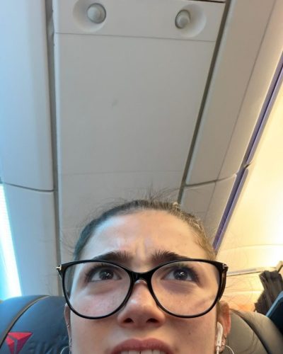 Charli D’Amelio playful gown with vibrant colors and statement earrings