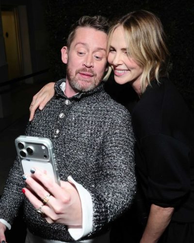 Charlize Theron fitted black shorts and black lace-accented top