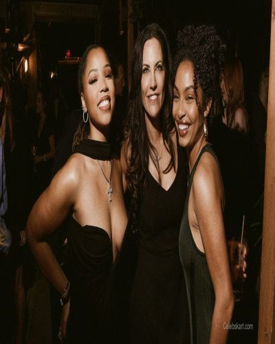 Chloe Bailey in a black gown with a plunging neckline