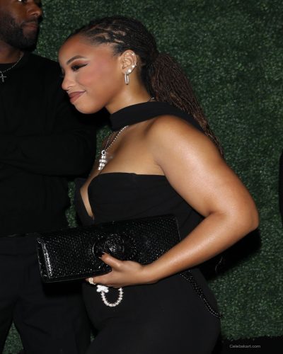 Chloe Bailey wearing a black gown paired with a black clutch