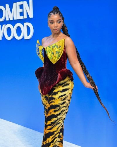 Chloe Bailey in long braids complementing vibrant gown style.