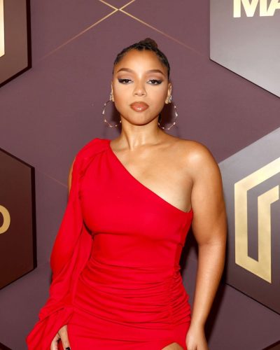 Chloe Bailey in a vibrant red gown with thigh-high slit