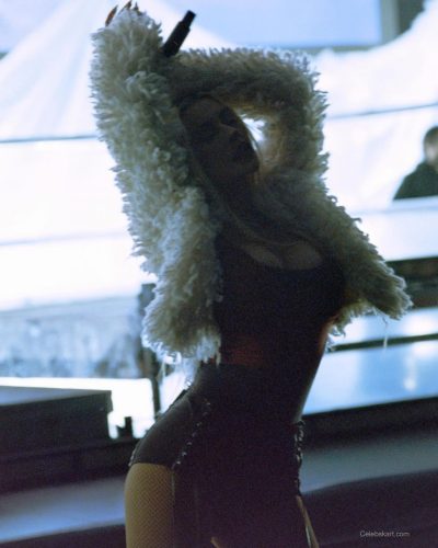 Christina Aguilera in fitted black bodysuit with elegant jacket