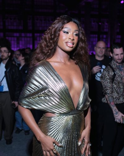 Coco Jones in chic gold dress with striking design elements
