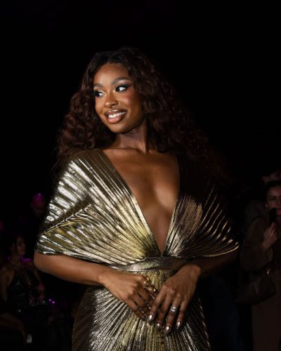 Coco Jones wearing intricately designed dress with daring neckline