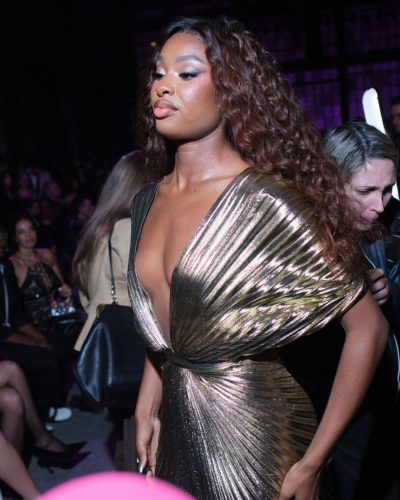 Coco Jones in radiant gold gown with contemporary style