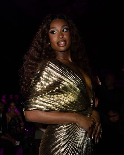Coco Jones in luxurious gold gown with graceful lines