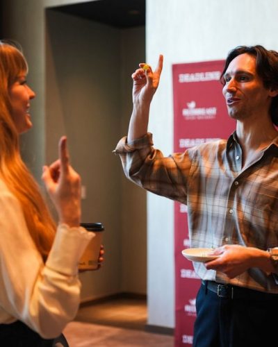 Debby Ryan in vibrant red dress with ruffled sleeves.