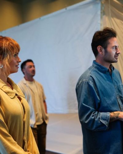 Dakota Fanning in chic light blue shirt paired with beige trousers.