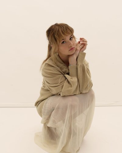 Debby Ryan in classic navy dress with subtle shimmer.