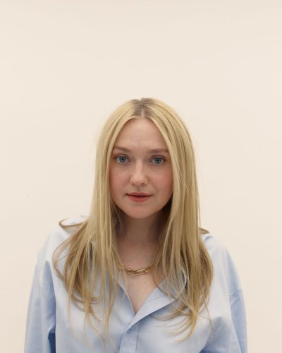 Debby Ryan in stylish black dress with floral patterns.