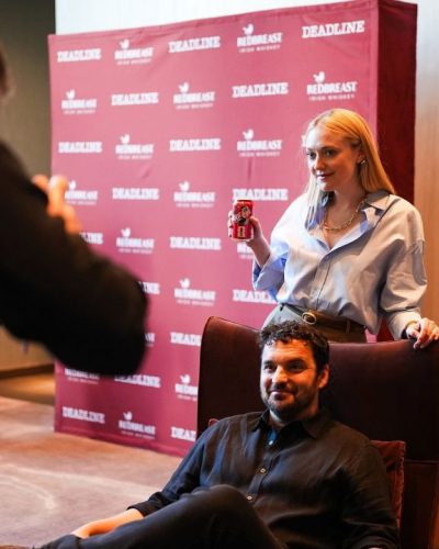 Debby Ryan in sophisticated black jumpsuit with wide legs.