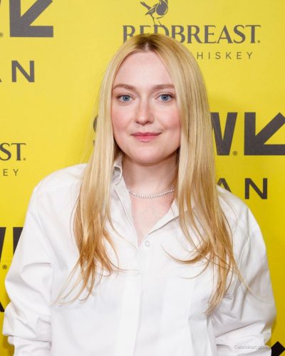 Dakota Fanning in white cropped shirt paired with black skirt