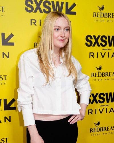 Dakota Fanning dressed in black skirt and cropped white blouse