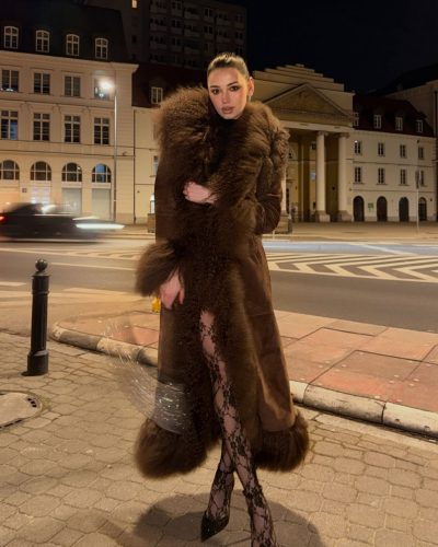 Daria Zaritskaya in black lace leggings and a luxurious faux fur coat.