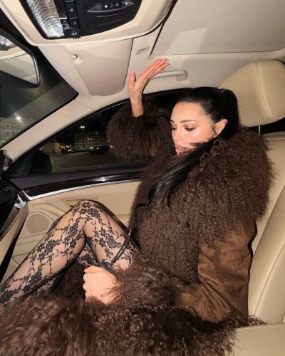 Daria Zaritskaya in black lace leggings and stylish embellished heels.