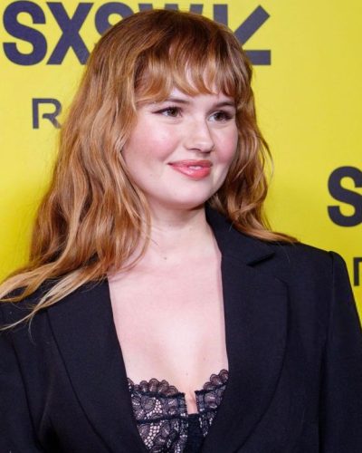 Debby Ryan in fashion-forward black ensemble with bold accents