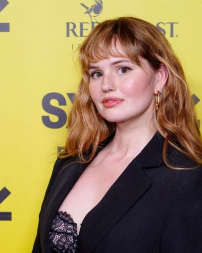 Debby Ryan in vibrant yellow enrollment banner background