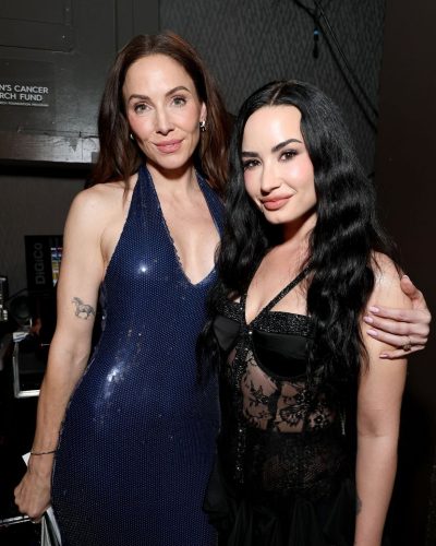 Demi Lovato with black lace bodysuit and stylish thigh-high boots