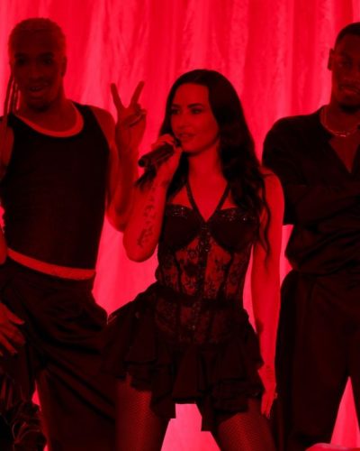 Demi Lovato in fitted lace bodysuit and dramatic ruffled skirt