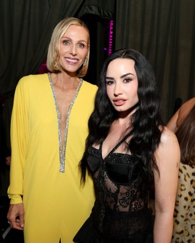 Demi Lovato wearing thigh-high black boots and lace bodysuit