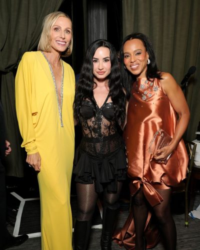 Demi Lovato with black lace bodysuit and fashionable thigh-high boots