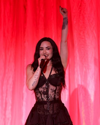 Demi Lovato wearing black lace bodysuit and bold ruffled skirt
