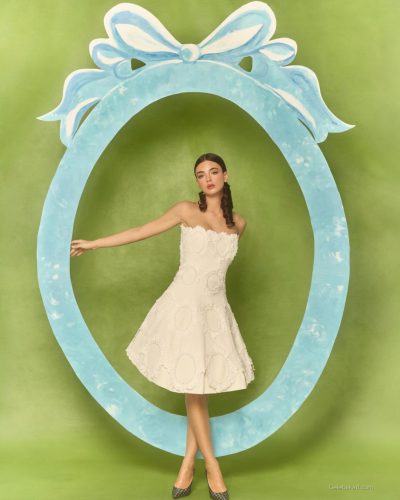 Deva Cassel in pastel floral dress with relaxed style.